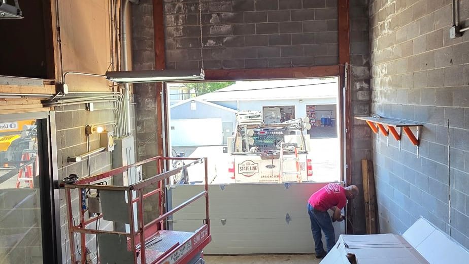 First sections of a commercial door going into a tall warehouse opening in Independence, MO
