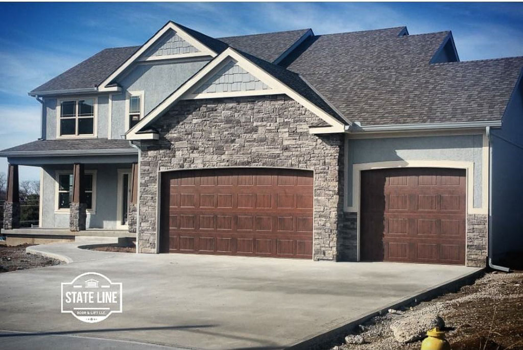 3-car garage door installation on stone craftsman home in Cleveland, MO