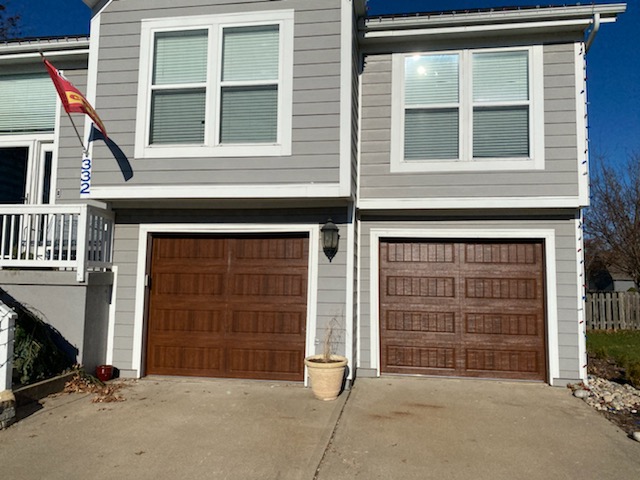 Oak finish carriage doors installed on modern home in Lee's Summit, MO